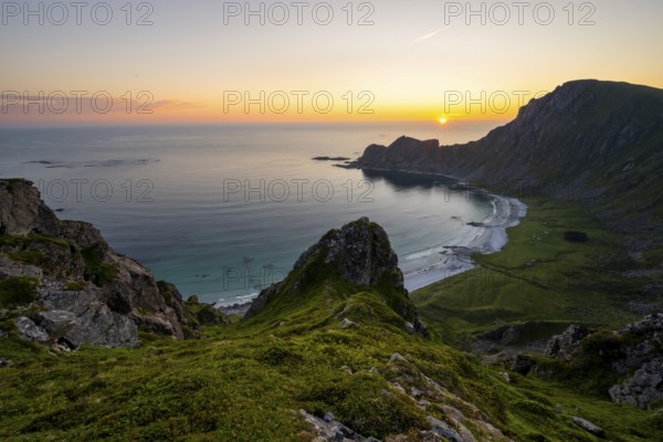 View of coastal landscape at sunset, cliffs and summit of Måtind or Måtinden, Høyvika beach and sea, Andøya island, Vesterålen, Nordland Norway