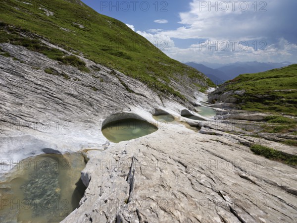Glacier mill with glacier pots on the Trinser Alp Mora, Trin, Canton Graubünden, Switzerland, Europe