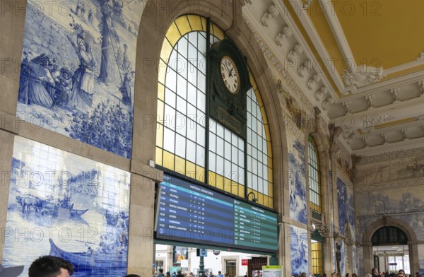 Azulejos tiles and clock interior Sao Bento railway station building, city of Porto, Portugal, Europe
