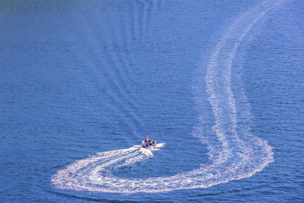 Motorboat that has made a turn on the sea with white wake pattern, Crozon peninsula, Bretagne, France, Europe