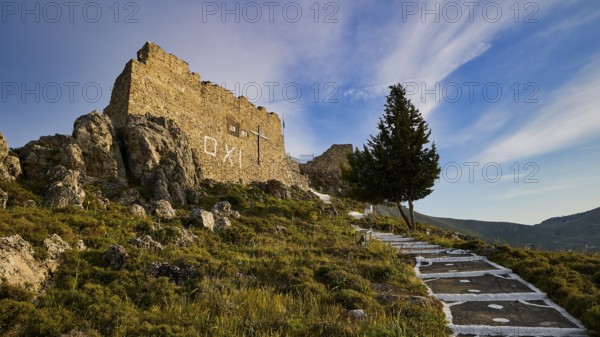 Rock ruins with path and tree, under a wide blue sky with clouds, Archangelos, castle, place, castle of Archangelos, Rhodes, Dodecanese, Greek Islands, Greece, Europe