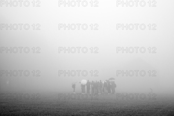 Group of visitors in the fog at beech forest concentration camp, today a concentration camp memorial, Weimar, Thuringia, Germany, Europe