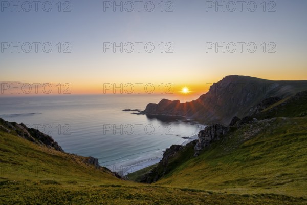 View of coastal landscape at sunset, cliffs and summit of Måtind or Måtinden, Høyvika beach and sea, Andøya island, Vesterålen, Nordland Norway