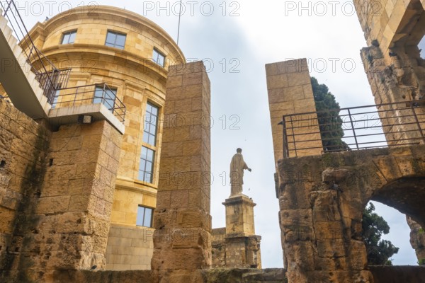 Roman statue standing tall amidst the ruins of tarragona, showcasing the city's rich historical heritage