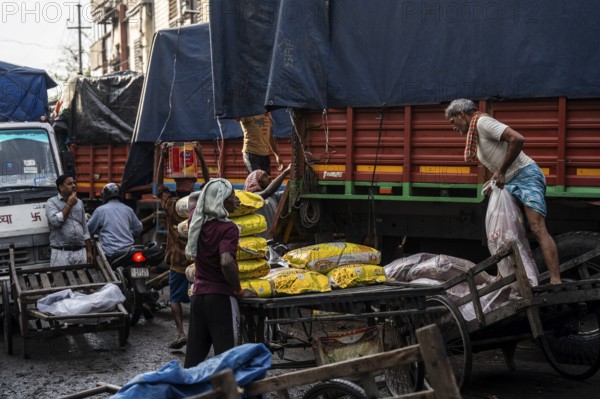 GUWAHATI, INDIA - MAY 1: Labourers carries goods in a wholesale market, in Guwahati, India, on May 1, 2025. May Day or Workers Day is a global holiday celebrated on May 1st to honor workers and their contributions, Asia