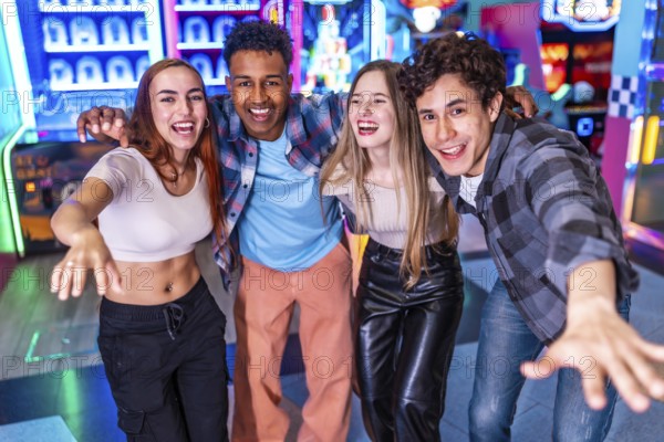 Four young multiethnic friends are enjoying their weekend together at an arcade, playing games and having a blast