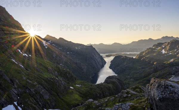 Picturesque mountain landscape at sunrise with sun star, fjord Trollfjord and Raftsund, hike to Trollfjord Hytta, Lofoten, Nordland, Norway, Europe