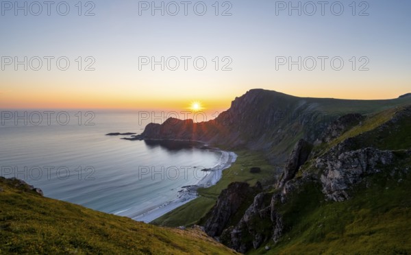 View of coastal landscape at sunset, cliffs and summit of Måtind or Måtinden, Høyvika beach and sea, Andøya island, Vesterålen, Nordland Norway