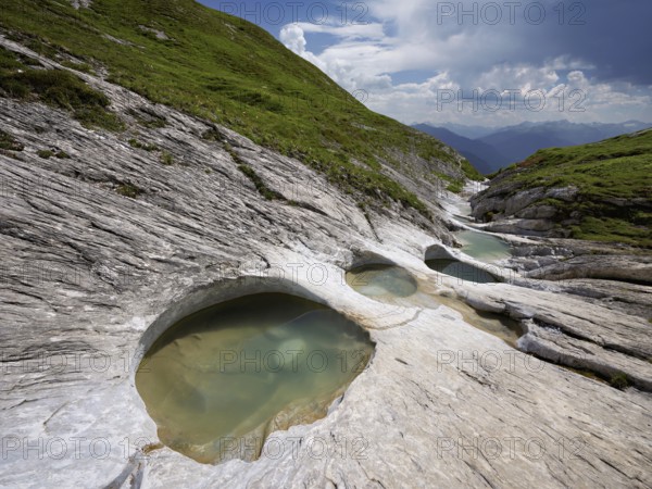 Glacier mill with glacier pots on the Trinser Alp Mora, Trin, Canton Graubünden, Switzerland, Europe
