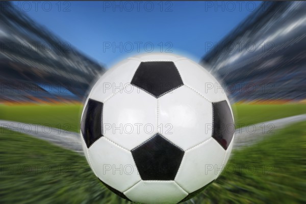 Symbolic image of football: Close-up of a black and white football in a football stadium