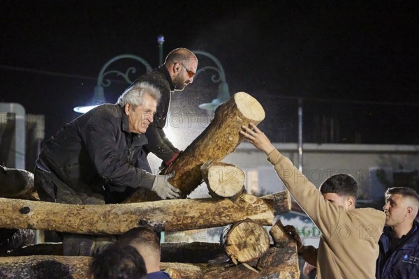 Men working together at night to build a large pile of wood for a fire, Easter fire Psinthos, Holy Saturday, Easter, Psinthos, Rhodes, Dodecanese, Greek Islands, Greece, Europe