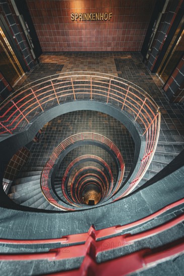 Vertical view from above through a spiral staircase in a building called Sprinkenhof, Hamburg, Germany, Europe
