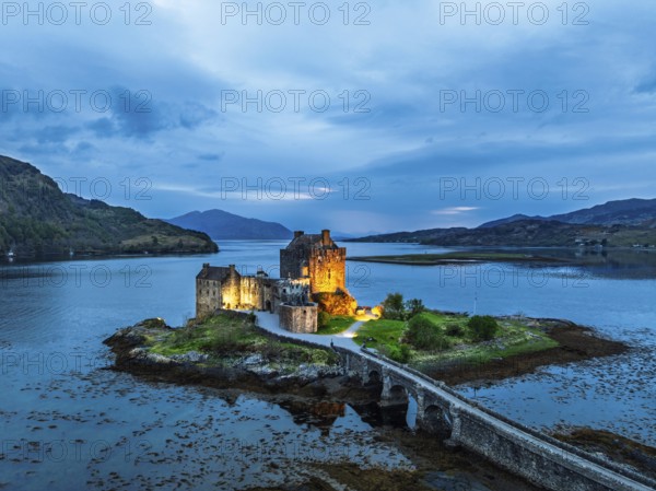 Night over Eilean Donan Castle and Loch Duich from a drone, Isle of Skye, Highlands, Scotland, England, United Kingdom, Europe