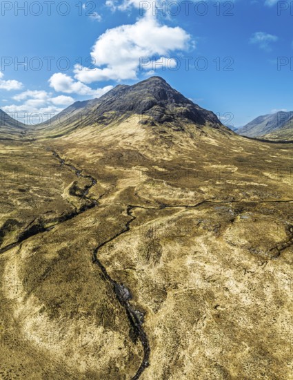 Panorama of Buachaille Etive Beag and Three Sisters in Glencoe over Moors and Road A82 from a drone, Highlands, Scotland, United Kingdom, Europe