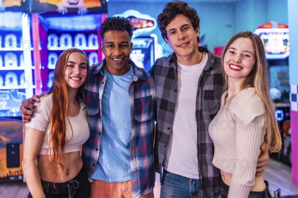 Four young multiethnic friends are smiling and having fun at an arcade, enjoying various games and entertainment options