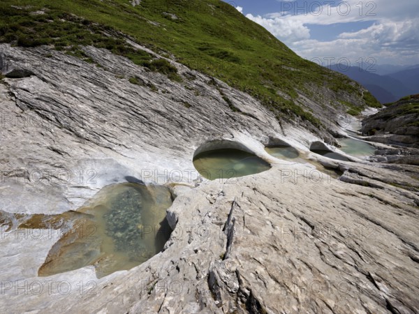 Glacier mill with glacier pots on the Trinser Alp Mora, Trin, Canton Graubünden, Switzerland, Europe