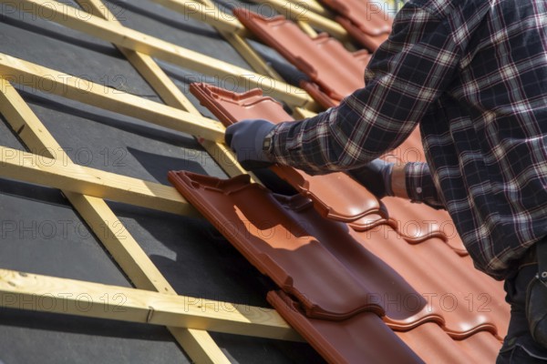Roofer covering a tiled roof