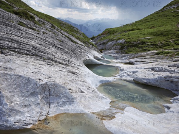 Glacier mill with glacier pots on the Trinser Alp Mora, Trin, Canton Graubünden, Switzerland, Europe