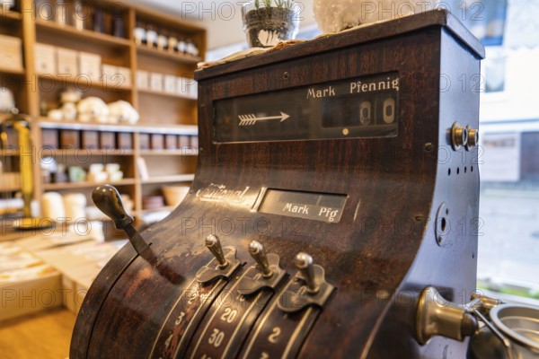 Antique cash register in a shop with ceramics and wooden shelves in the background, Calw Tannery Museum, Black Forest, Germany, Europe