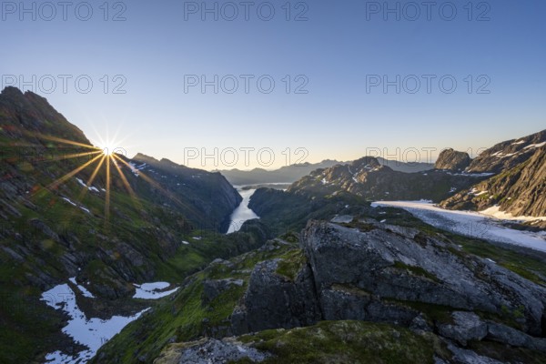 Picturesque mountain landscape at sunrise with sun star, fjord Trollfjord and Raftsund, hike to Trollfjord Hytta, Lofoten, Nordland, Norway, Europe