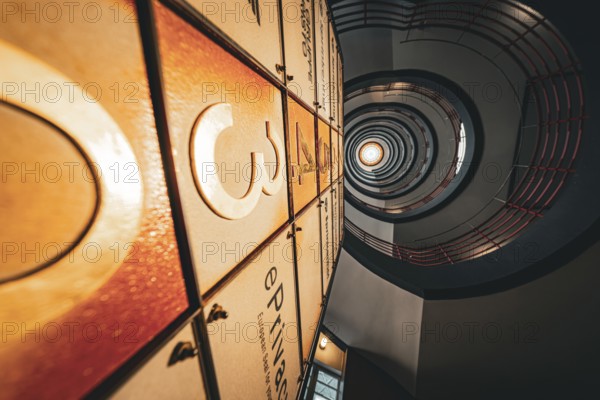Dramatic view upwards through a spiral staircase with warm light, SPRINKENHOF, Hamburg, Germany, Europe