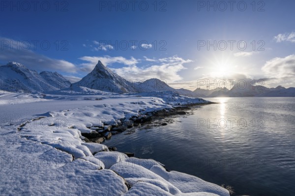 Snowy landscape with mountains and fjord, Volandstinden mountain, Fredvang, Flakstadøya, Lofoten, Norway, Europe