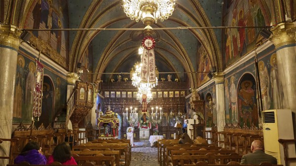 Interior of a church with paintings and chandeliers, people sitting in the pews, Easter fire Psinthos, Holy Saturday, Easter, Psinthos, Rhodes, Dodecanese, Greek Islands, Greece, Europe