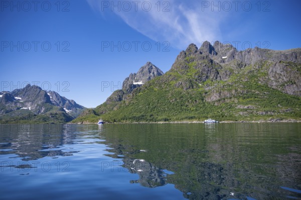 Mountain peaks at Raftsund reflected in the water, fjord landscape with mountains, Lofoten, Nordland, Norway, Europe
