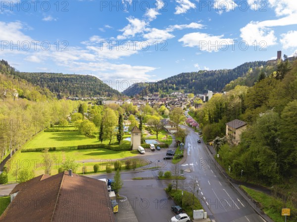 View of town with neighbouring forest and hills under blue sky, Bad Liebenzell, district Calw, Black Forest, Germany, Europe