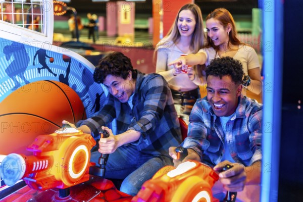 Young adults enjoying time together while playing arcade games in a vibrant bowling alley, filled with laughter and excitement