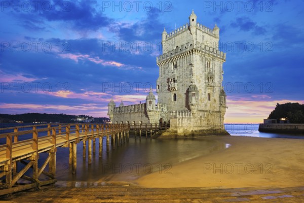 Belem Tower or Tower of St Vincent, famous tourist landmark of Lisboa and tourism attraction, on the bank of the Tagus River (Tejo) after sunset in dusk twilight with dramatic sky. Lisbon, Portugal, Europe