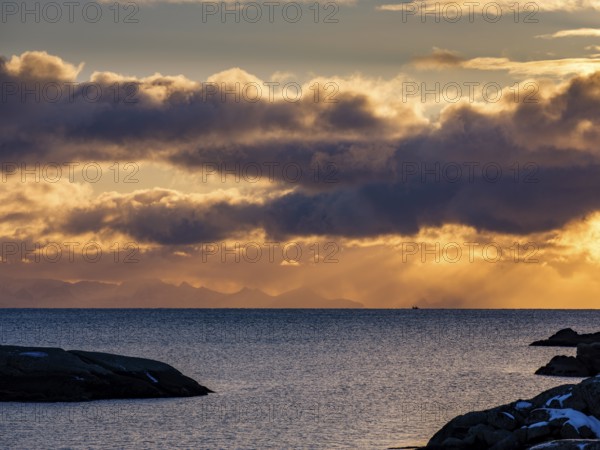 Morning atmosphere at the coast of Ballstad, behind the mountains of the mainland, Vestvagoy island, Lofoten, Norway, Europe