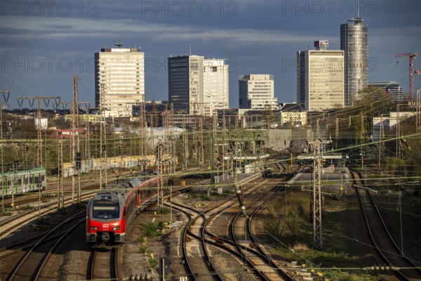 Train on the tracks west of Essen central station, city centre skyline, regional express train, North Rhine-Westphalia, Germany, Europe