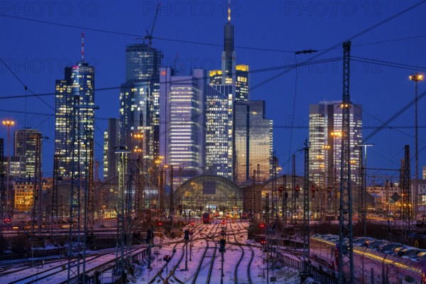 Railway tracks in front of the main railway station in Frankfurt am Main, skyline of skyscrapers in the Cit, winter, snow, dusk, Hesse, North Rhine-Westphalia