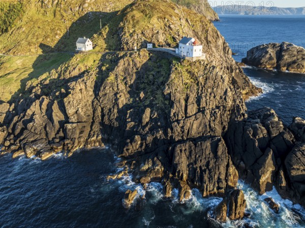 Aerial view of Krakenes Fyr lighthouse, lighthouse located on steep cliff, norwegian coast north of Maloy, Vestland, Norway, Europe