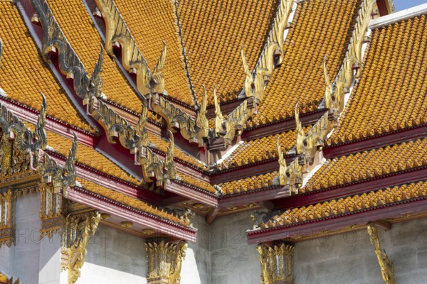 Roof decoration at the Uposatha Hall, Ubosot, the roof is staggered in three tiers and covered with rows of golden yellow glazed Chinese tiles, the last tile of each row at the eaves represents a heavenly angel offering the traditional Thai obeisance Wai to the viewer with folded hands, Wat Benchamabophit, marble temple, Bangkok, Thailand, Asia