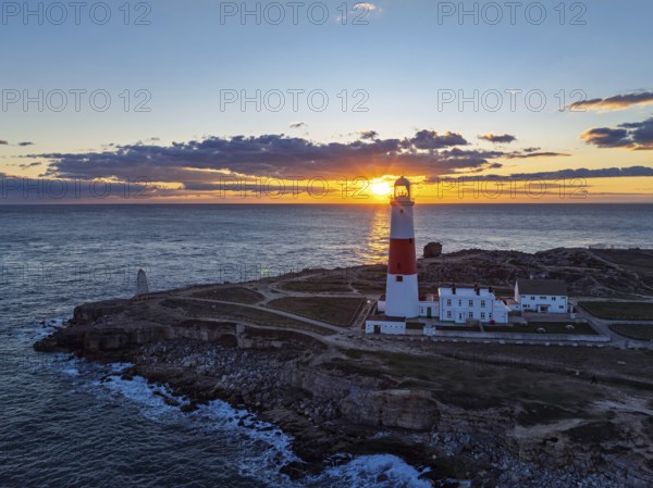 Sunset over Portland Bill Lighthouse from a drone, Portland Bill, Isle of Portland, Dorset, England, United Kingdom, Europe