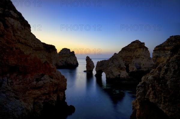Coloured cliffs and sunrise, rocks in the sea, Ponta da Piedade, Lagos, caves, cliffs, Atlantic Ocean, Algarve, Portugal, Europe