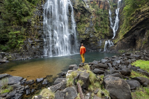 Young man standing in front of a waterfall, Lisbon Falls, long exposure, near Graskop, Mpumalanga, South Africa, Africa
