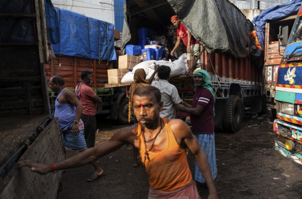 GUWAHATI, INDIA - MAY 1: Labourers carries goods in a wholesale market, in Guwahati, India, on May 1, 2025. May Day or Workers Day is a global holiday celebrated on May 1st to honor workers and their contributions, Asia