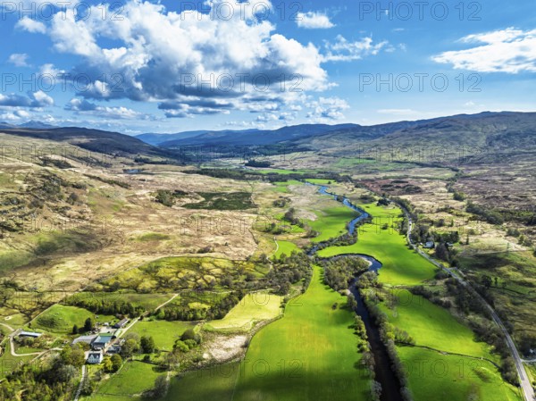 Farms and Mountains over River Dochart and Road A85 from a drone, Perthshire, Scotland, UK