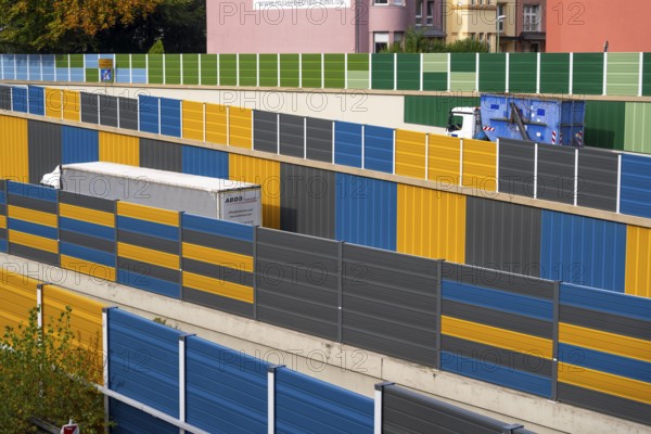 Colourful noise barriers on the A52 motorway, at the Essen-Rüttenscheid junction, the noise barriers were rebuilt in a colourful design as part of the motorway renovation, North Rhine-Westphalia, Germany, Europe