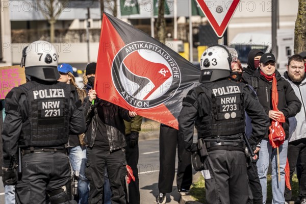 Left-wing counter-demonstration at an ultra-right demo of the so-called neo-Nazi group Jung und Stark, JS, demonstrating in the city centre of Essen, demanding remigration of foreigners, extreme left-wing counter-demonstrators, of the Antikapitalistische Aktion, Essen, North Rhine-Westphalia, Germany, Europe