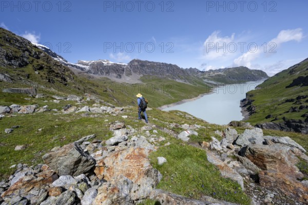 Mountaineer on hiking trail in front of Lac des Dix reservoir, Valais Alps, Valais, Switzerland, Europe