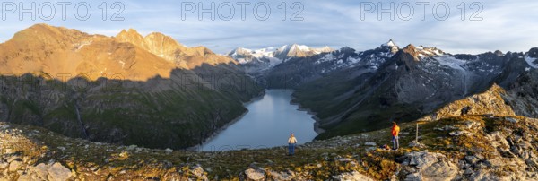 Hikers enjoying the alpine panorama at Lac de Dix, sunset in the mountains, reservoir, Valais Alps, Valais, Switzerland, Europe