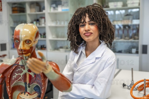 Confident medical student learning human anatomy using anatomical model in a university laboratory