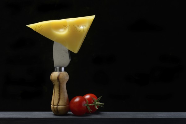 A piece of Swiss Emmental cheese on a cheese knife