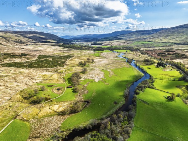 Farms and Mountains over River Dochart and Road A85 from a drone, Perthshire, Scotland, UK