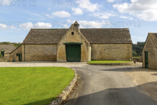 Historic nineteenth century farmyard stone barn building, Yanworth, Gloucestershire, England, UK
