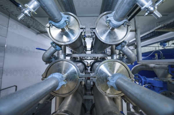 View of an industrial pipe system with many metal elements and blue coatings, ENCW Netze Calw waterworks, Calw, Black Forest, Germany, Europe
